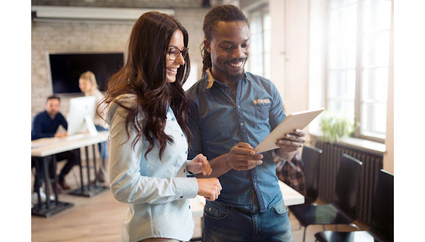 Two people looking at a document