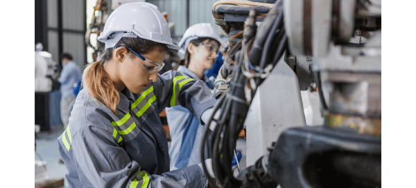 Two workers in a factory assembling cars.